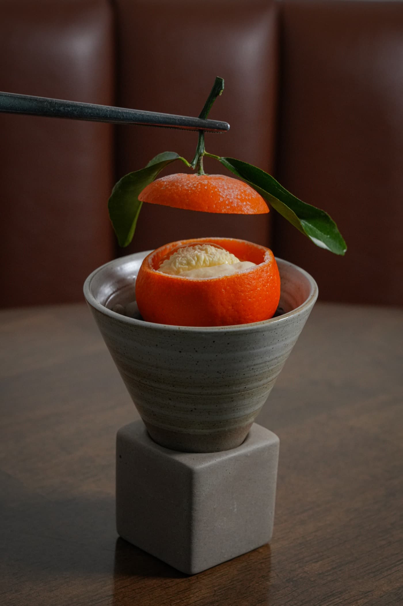 A mandarin opened to reveal a filled citrus shell, from Chef Limardo's work at Imperfecto and Seven Reasons.